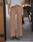Frank & Eileen Riley wide leg trousers styled with a white top and brown loafers in a doorway setting.