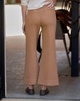 Wide leg Frank & Eileen Riley trousers in brown, seen from the back as worn in a doorway, casual lifestyle setting.