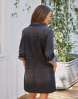 Black denim Frank & Eileen Ireland Utility Dress with six pockets, shown outdoors for a casual spring look.