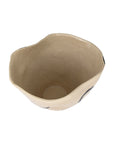 The Import Collection's handmade Clyde Bowl in beige features an uneven, wavy rim and an organic, asymmetrical shape—perfect as a modern centerpiece, especially when viewed from above on a white background.