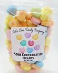 A clear bag of Faire's Lake Erie Valentine Candy—pastel-colored sweets with cute phrases like "Be Mine" and "Love You." Perfect for Valentine's Day. Net weight: 4 oz.
