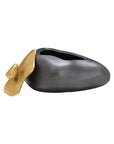 The Import Collection's Finkle Large Box is a modern, abstract decorative piece featuring a smooth dark gray form with a gold petal-shaped accent, displayed elegantly against a plain white background.