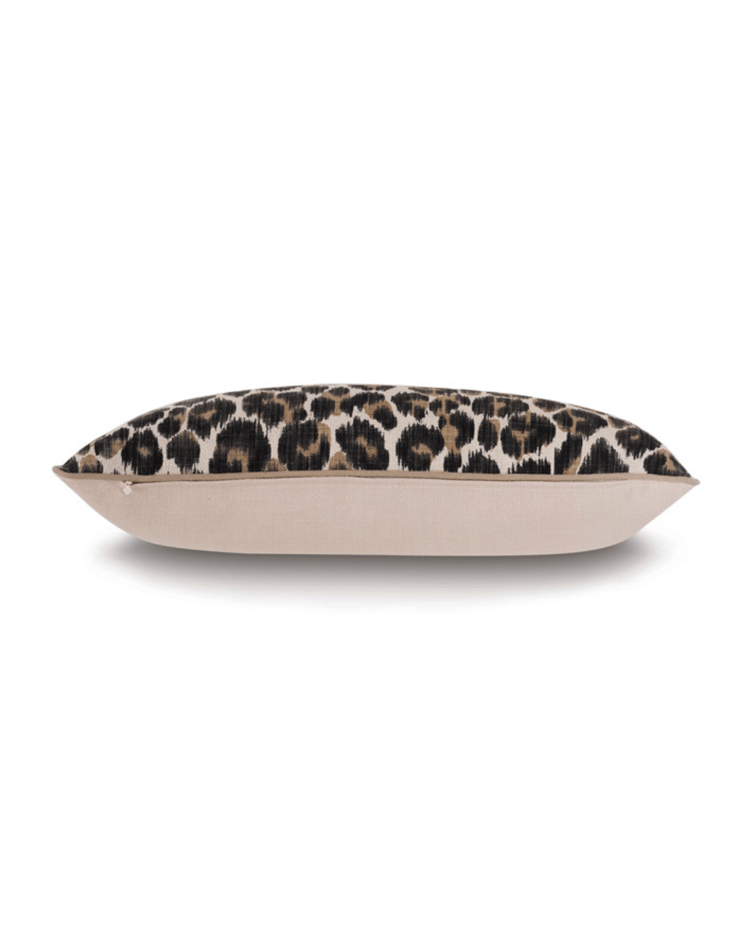 Gira Spot Pillow with a leopard print on one side and a plain beige fabric on the other, displayed against a bungalow-inspired backdrop in Scottsdale, Arizona by Eastern Accents.