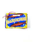 The "Sardine Tin Luxury Soap" by Faire features a colorful design of blue and yellow fish illustrations, evoking the charm of Lisbon, Portugal. Wrapped in red and white string, it blends seaside allure with indulgence for a luxurious experience.