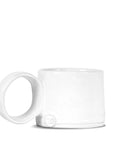 The Montes Doggett Espresso Cup NO. 926 is a minimalist white ceramic cup with a large round handle and handcrafted look, set against a plain white background. This high fired cup is both dishwasher and microwave safe.