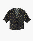 White blouse with ruffled V-neck and short puff sleeves, DOEN Henri Top in Buttercup Bouquet floral pattern.