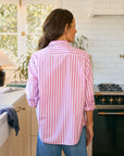 A woman in a Frank & Eileen BARRY Tailored pink and white striped button-up shirt.