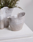 Pair of Claribel Vase Short by Accent Decor on white surface, one holding green foliage, modern decorative style.