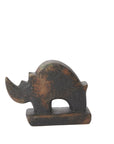 The Accent Decor Rhino Sculpture features a small, rustic, minimalist design with a mottled brown and dark gray finish on a rectangular base—perfect as a unique home accent piece.
