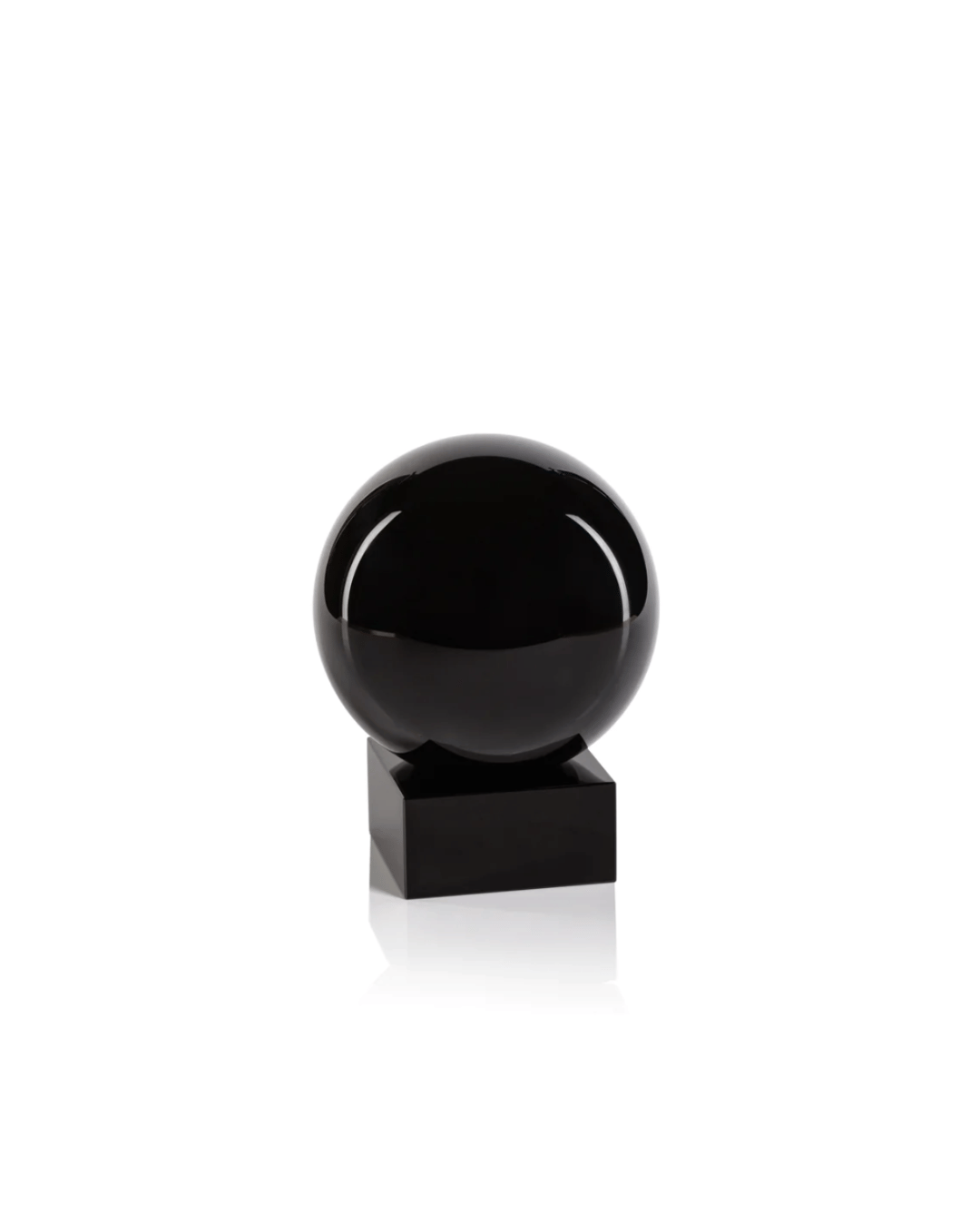 A Zodax Crystal Orb on Base sitting atop a black cubic pedestal, presented against a clean white background in a Scottsdale, Arizona bungalow.