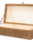 The Sarreid Gatsburg Shagreen Box is a rectangular, textured gold storage box with an open hinged lid, revealing a smooth cream interior. A gold chain holds the lid open, adding a touch of transitional elegance.