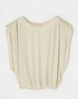 The MV Satin Shell Cap Top by Moussy is a cream, loose-fitting sleeveless blouse with a round neckline, subtle shoulder gathering, back button closure, and relaxed drape for effortless elegance.