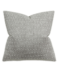 A light gray bow-shaped Clear Dotted Pillow from Eastern Accents, providing a modern and elegant appearance, reminiscent of Scottsdale Arizona style, isolated on a white background.