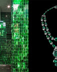 On the left, a bathroom with glossy green marble tiles embodies luxe green design. On the right, Hachette Book Group’s “G: Forever Green” shines like an ornate emerald and diamond necklace against a black background.