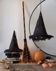 Light-up witch hat centerpiece with pumpkins and leaves, Halloween decor by Faire for Bungalow Furniture.