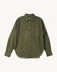 The CLOSED Oversized Shirt is olive green with long sleeves, a collar, white buttons, and a curved hem. It features a small black and white car pattern throughout and playful embroidered patches, inspired by classic denim shirt styles.
