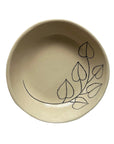The Floral 6" Tree Bowl by Faire is a cream-colored handmade stoneware bowl with a simple black leafy branch design on the inner surface.