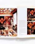 Slim Aarons: Women by Hachette Book Group is pictured open, revealing vibrant photos of ornately decorated rooms filled with art—evoking classic Hollywood style. One large image appears on the left, while three smaller images and text are on the right page.