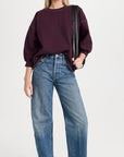 Rachel Comey Fond Sweatshirt in cream with blue jeans, casual style, plain backdrop, women’s clothing.