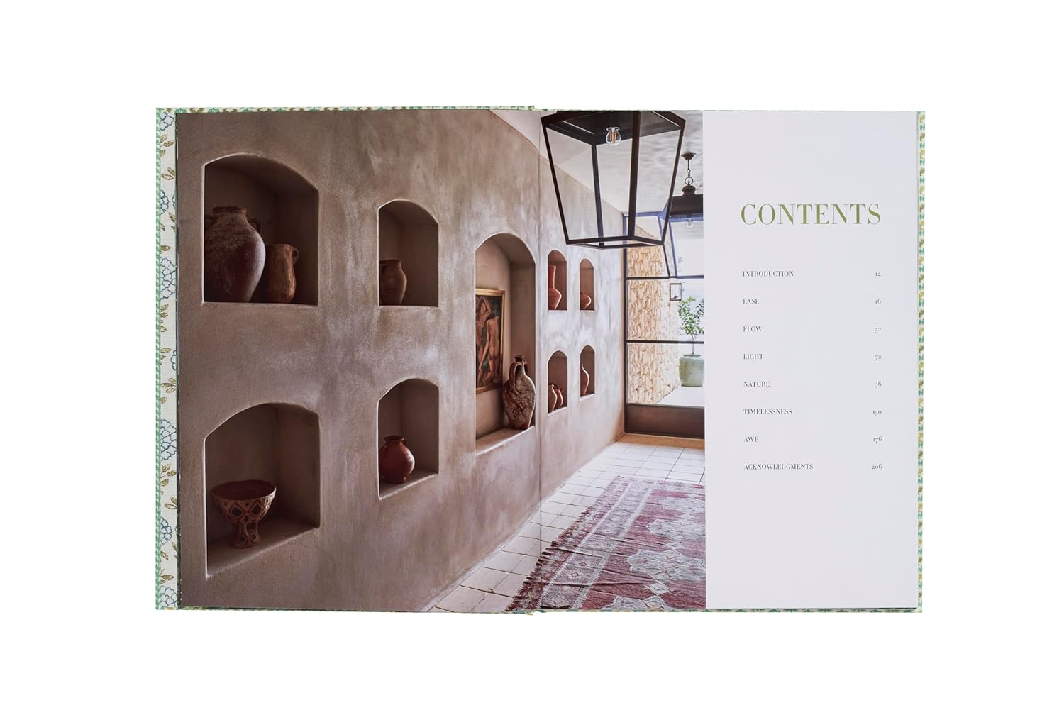 An open spread of "Natural Living by Design" by Hachette Book Group displays beige walls with built-in shelves of clay pottery and a contents page, all set on a patterned rug in sunlight for a fresh, healthy home feel.
