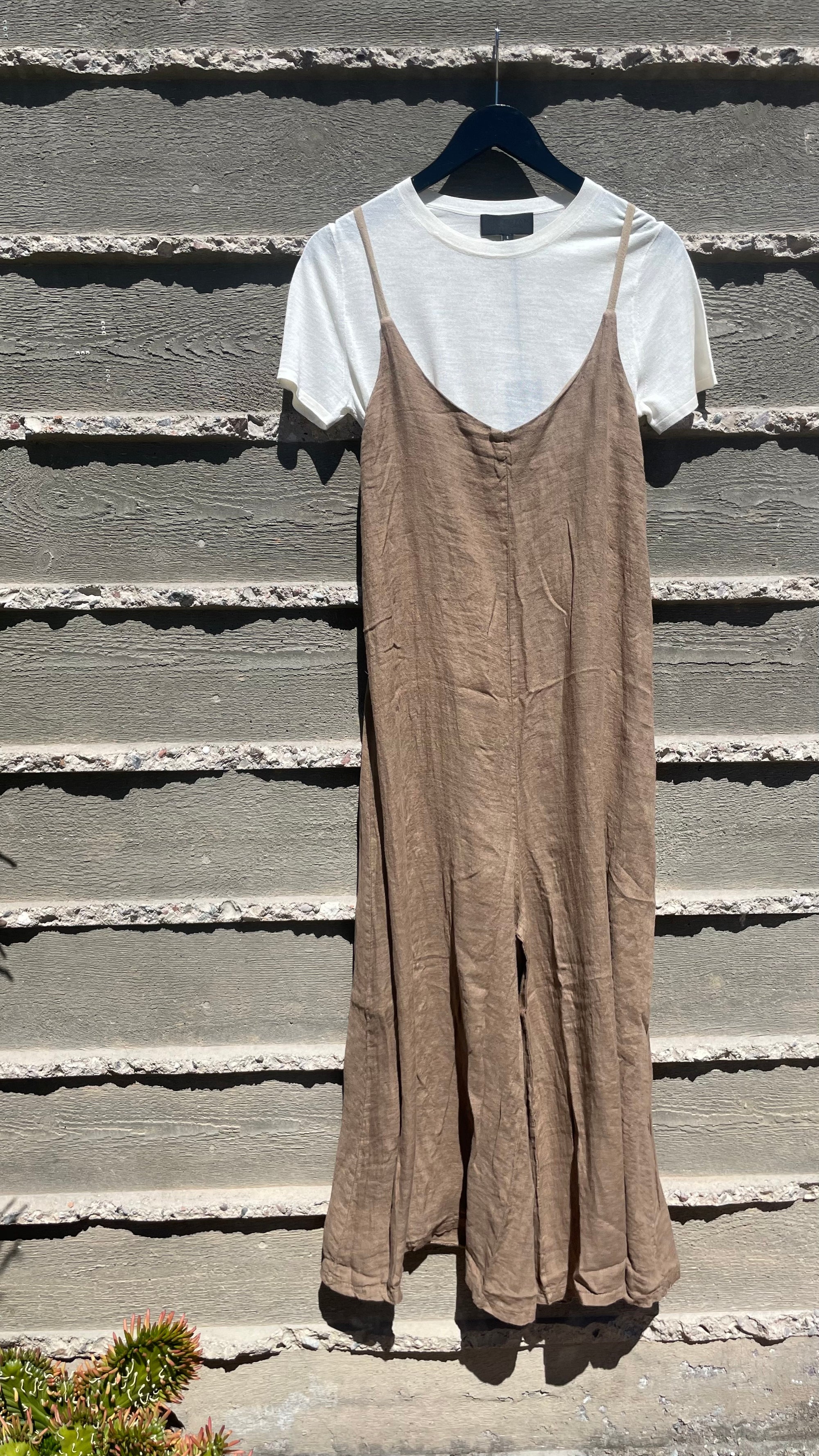 A white Linen Jumper and brown dress on a bungalow wall in Scottsdale, Arizona by Importations Eternelle Inc.