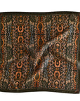 The Faire Wild Rag Silk Scarf features an intricate horseshoe, leaf, and floral pattern in orange, brown, and gold on black with a crumpled texture—an essential cowgirl accessory for any wardrobe.