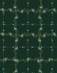 The Faire Double Sided Hand Towel features a dark green background with a grid of leafy vines and small white floral clusters—an elegant, eco-friendly choice for holiday décor.