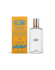 A clear glass bottle of Faire’s Blomb Eau de Parfum with a silver cap stands beside a yellow "BLOMB" box. Blue and white text and the number 23 emphasize its customizable, natural scent, perfect for anyone.