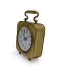 The Zentique Gold Table Clock Pewter features a vintage-inspired gold finish, Roman numerals, decorative handle, and rounded edges on two short legs—an elegant accent to bring timeless charm to any modern decor.