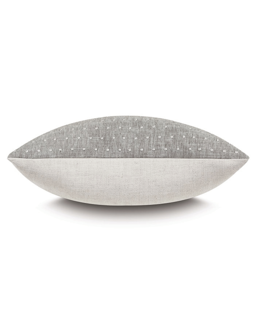 A two-toned Clear Dotted Pillow from Eastern Accents, with the top half in a textured gray fabric and the bottom half in smooth white, set against a white background in a Scottsdale bungalow.