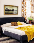 Inspired by Lauren Liess, "Down to Earth" from Hachette Book Group offers ideas for relaxed bedrooms featuring dark beds, white bedding, wooden nightstands, patterned pillows, floral curtains, and lots of natural light.