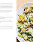 A large plate of tonnato salad sits on a light table next to extra sauce and a spoon—just one simple, delicious idea from Make More with Less by Hachette Book Group, perfect for easy recipes or using up leftovers.