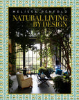 The "Natural Living by Design" book cover from Hachette Book Group features a plant-filled room with natural materials, large windows, cozy seating, soft light, and a blue and yellow patterned border.