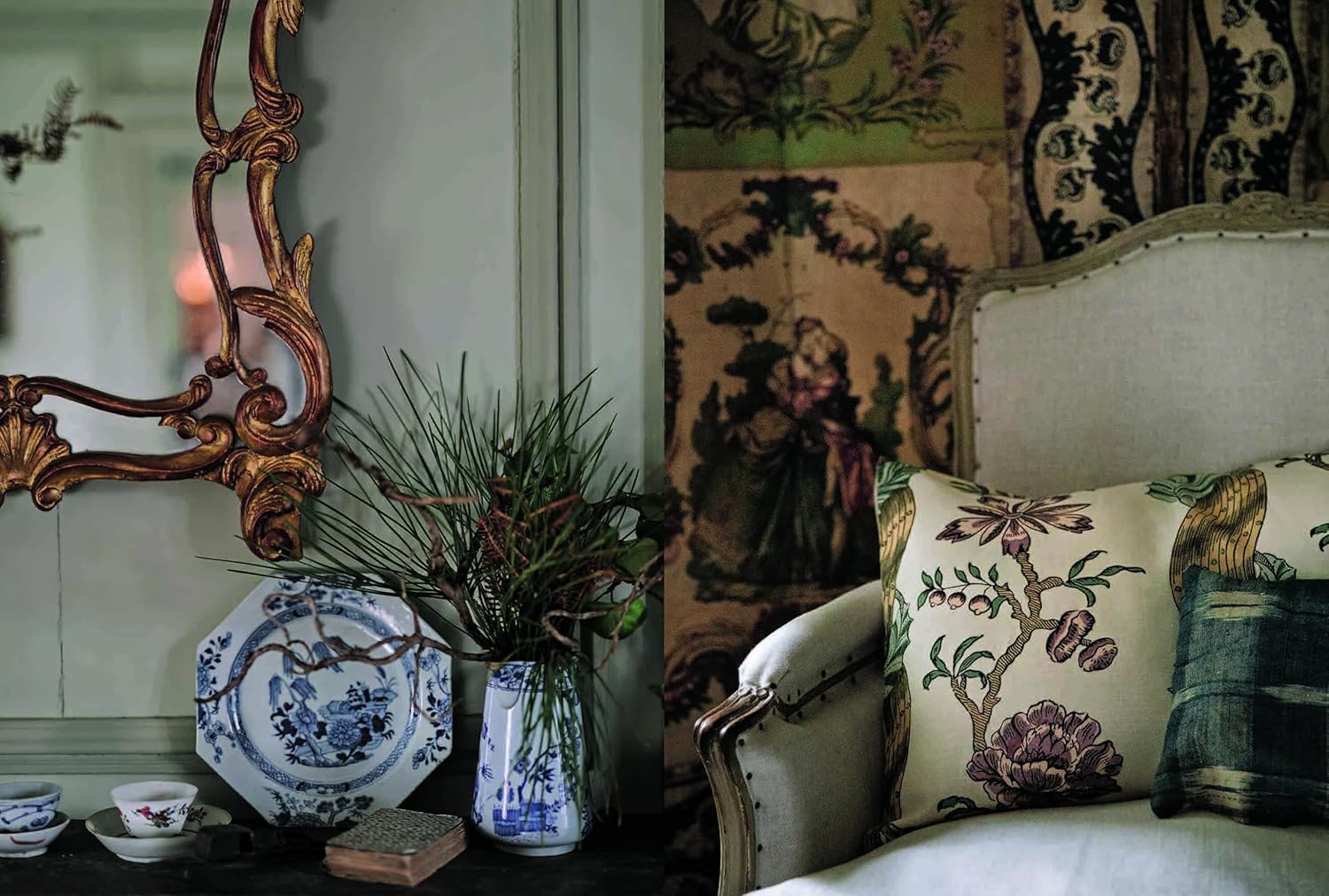A Year in the French Style" by Random House rests on a dark table beside an upholstered armchair with floral and plaid pillows, set against a patterned wall adorned with artisanal accents and a vintage tapestry.