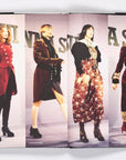 Four models showcase ’90s-inspired looks from "Nineties X Anna Sui" by Random House, featuring tailored jackets, baby-doll dresses, and heeled boots on a runway with bold text recalling Anna Sui’s legendary show style.