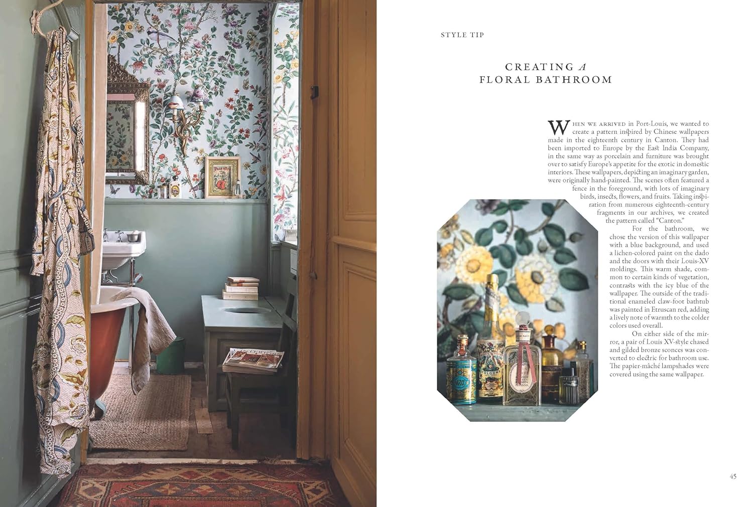 A vintage-inspired bathroom from "A Year in the French Style" by Random House features floral wallpaper, a compact sink, books on a bench, a patterned robe on the door, and a right-side close-up of assorted perfume bottles and jars.