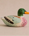 Pink hand-painted carved basswood duck by Faire, a charming accent for rustic and artisan-inspired spaces.