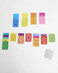 Fred Mae cards neatly arranged on a white surface, deck by Hachette Book Group sits nearby.