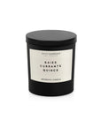 A black 8 OZ Candle With Lid by Faire features a white label and sits against a plain white background, inspired by diptyque style.