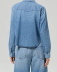 A person wearing a Citizens Of Humanity/AGOLDE cropped western shirt and matching wide-leg jeans, shown from the back against a plain light gray background.