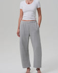 Heather grey Citizens Of Humanity Miro sweatpants styled with a white ribbed tee and black heels.