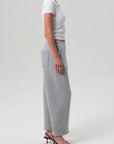 Heather grey Miro Sweatpant by Citizens Of Humanity/AGOLDE styled with a white crop top and black heels.