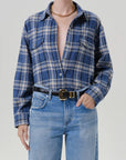 Citizens Of Humanity vintage marina plaid shirt in blue tones, styled with light jeans and a gold chain necklace.