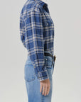 Marina plaid vintage long button up shirt by Citizens Of Humanity/AGOLDE with light blue jeans, side view.
