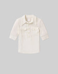 The Amina Polo Shirt by Citizens Of Humanity/AGOLDE is a children's off-white, ribbed cotton long-sleeve with a collar, button-up placket, and front pockets with button flaps, shown on a plain gray background.