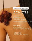 A person with smooth, tan skin and long dark hair faces away, showing a bare shoulder as a reddish-brown achiote seed pod hangs above. Text highlights Rahua Enchanted Island Body Glow Wash by Faire: boosts collagen, protects and smooths skin.
