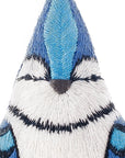 Close-up of a blue jay crafted with blue, black, and white thread from the Faire Blue Jay Embroidery Kit. The stitching creates a stylized, symmetrical Blue Jay Pattern on a white background.