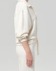 Vintage cream polo and matching pants by Citizens Of Humanity/AGOLDE, modeled against a light grey backdrop.