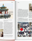 An open book from Ingram Book Company's "New York Times 36 Hours World 150 Cities" shows photos of a Chinese pavilion, chefs, and a street market with travel info on Beijing and China.