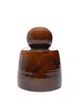 The Faire Amber Stash Jar, a brown ceramic container with a rounded lid reminiscent of hand-thrown stash jars or a small barrel, is shown against a plain white background.